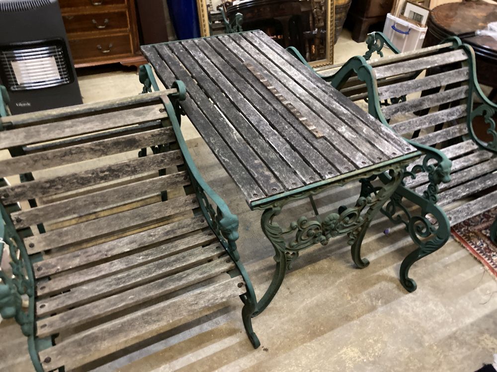 Four cast metal slatted wood garden armchairs and matching rectangular table, table 126 x 67cm, height 65cm